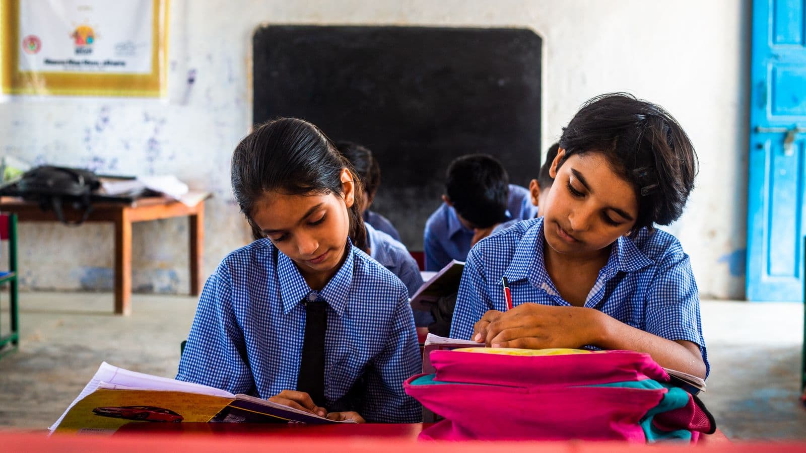 Indian school students concentrating on their written work in class